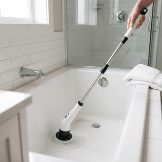 Electric spin scrubber cleaning a white bathtub